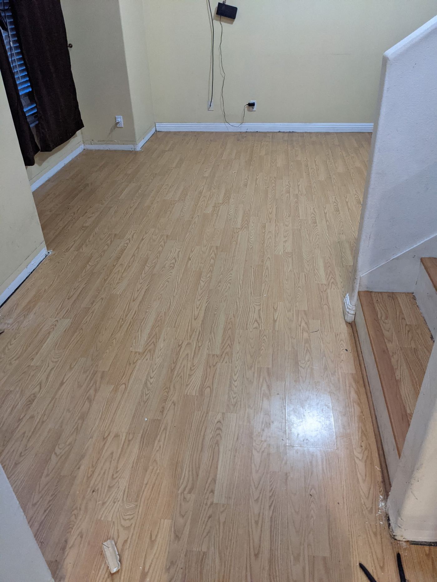 Finished plank flooring by the stairwell